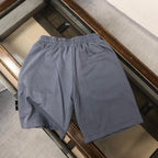 Stone Island shorts back view, slate blue with elastic waist and patch pocket
