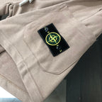 Stone Island beige shorts with black logo patch near front pocket seam