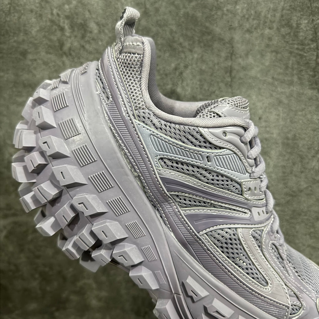 Lilac sneaker outsole detail with raised lugs and side overlay accents