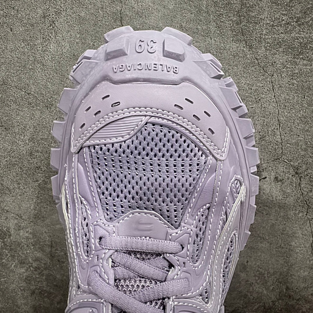 Front of lilac sneaker showing mesh toe, stitched overlays, and lace-up