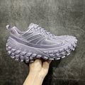 Lilac sneaker with textured panels, lace-up front, and chunky tread sole