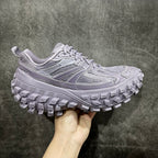 Lilac sneaker with textured panels, lace-up front, and chunky tread sole
