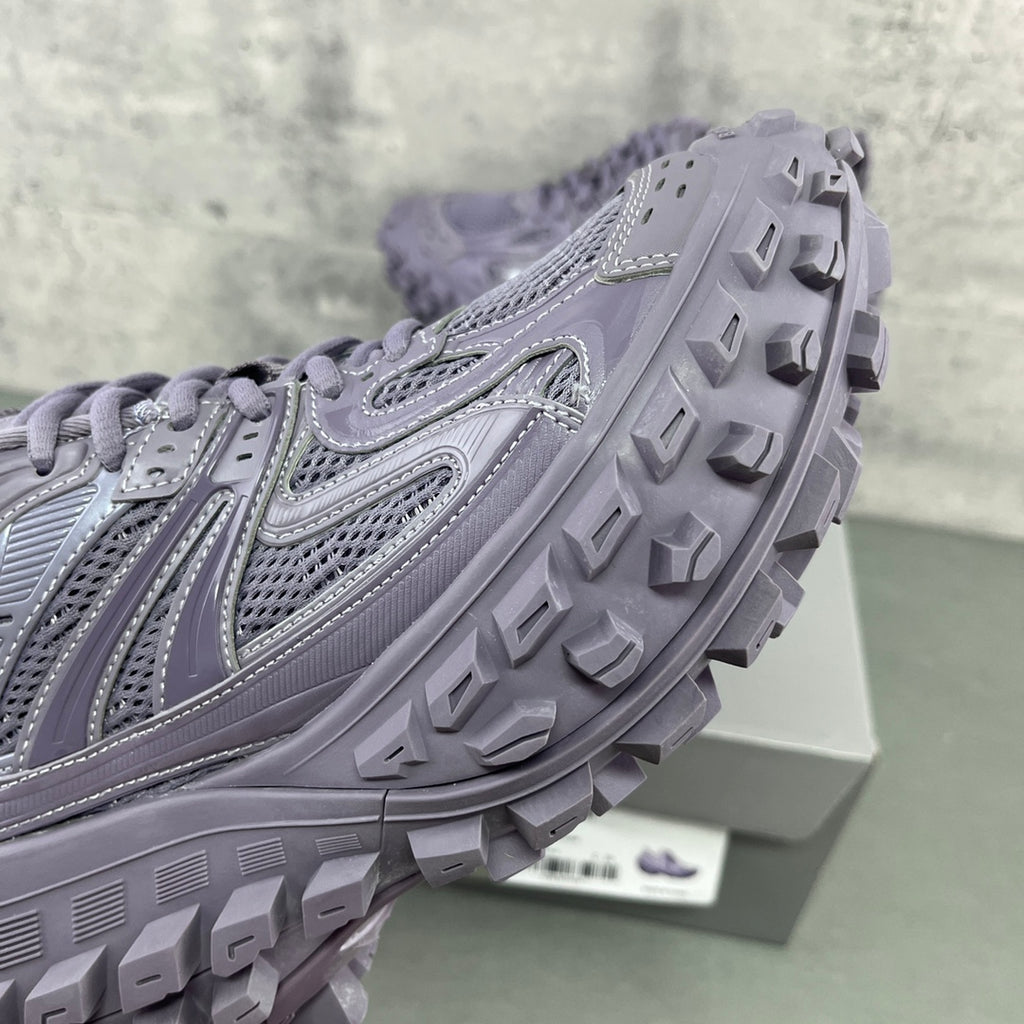 Lavender trail sneaker outsole with deep tread lugs and side panel stitching detail