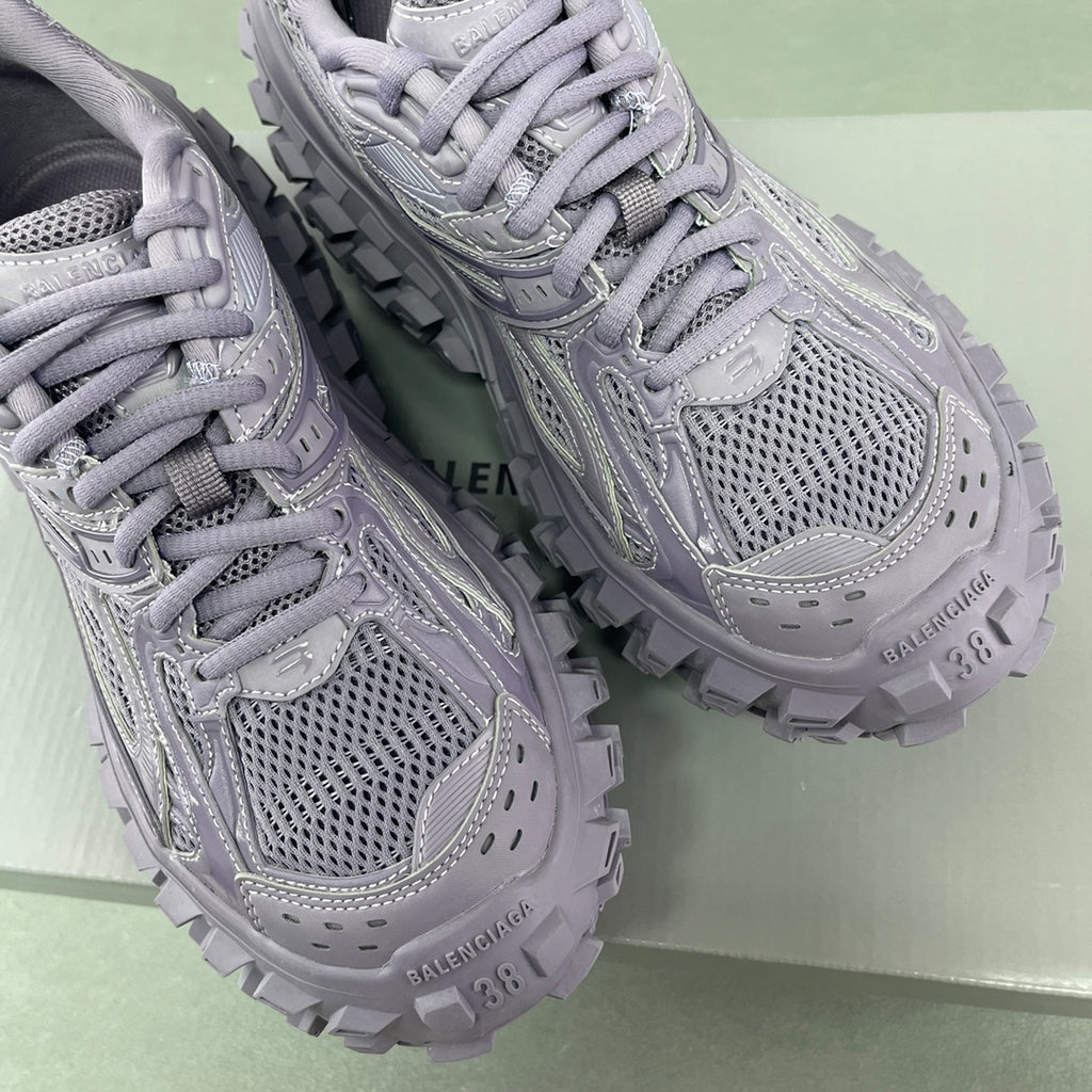 Lavender lace-up sneakers close-up with mesh upper, padded tongue, and chunky outsole