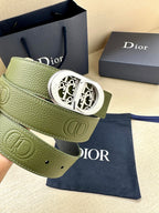 Green leather belt with silver-toned oval buckle and embossed logo panel