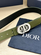 Green leather belt with silver-toned buckle and embossed circular logo detail