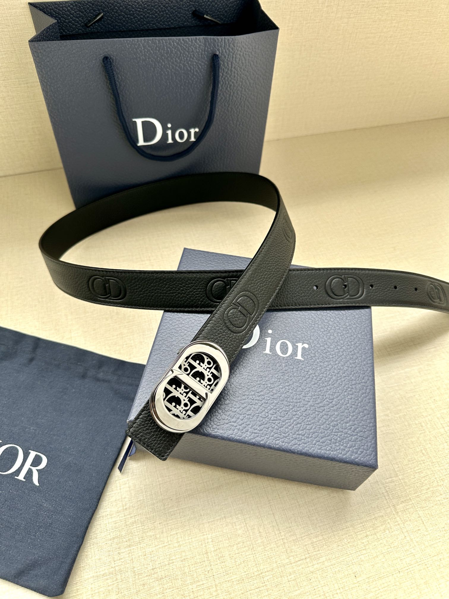 Dior belt with dark leather strap and silver-tone oval monogram buckle