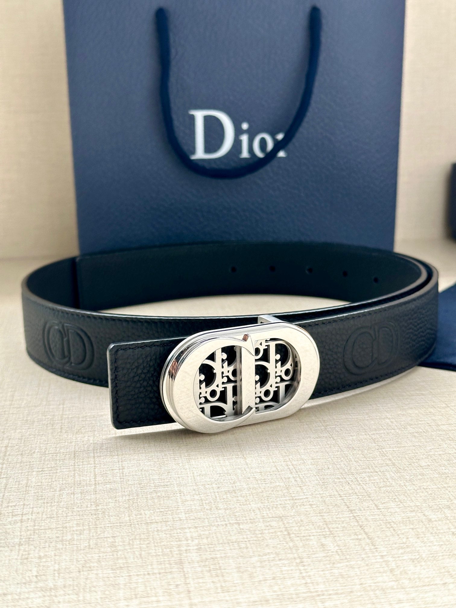 Dior belt with dark leather strap and silver-tone oval monogram buckle