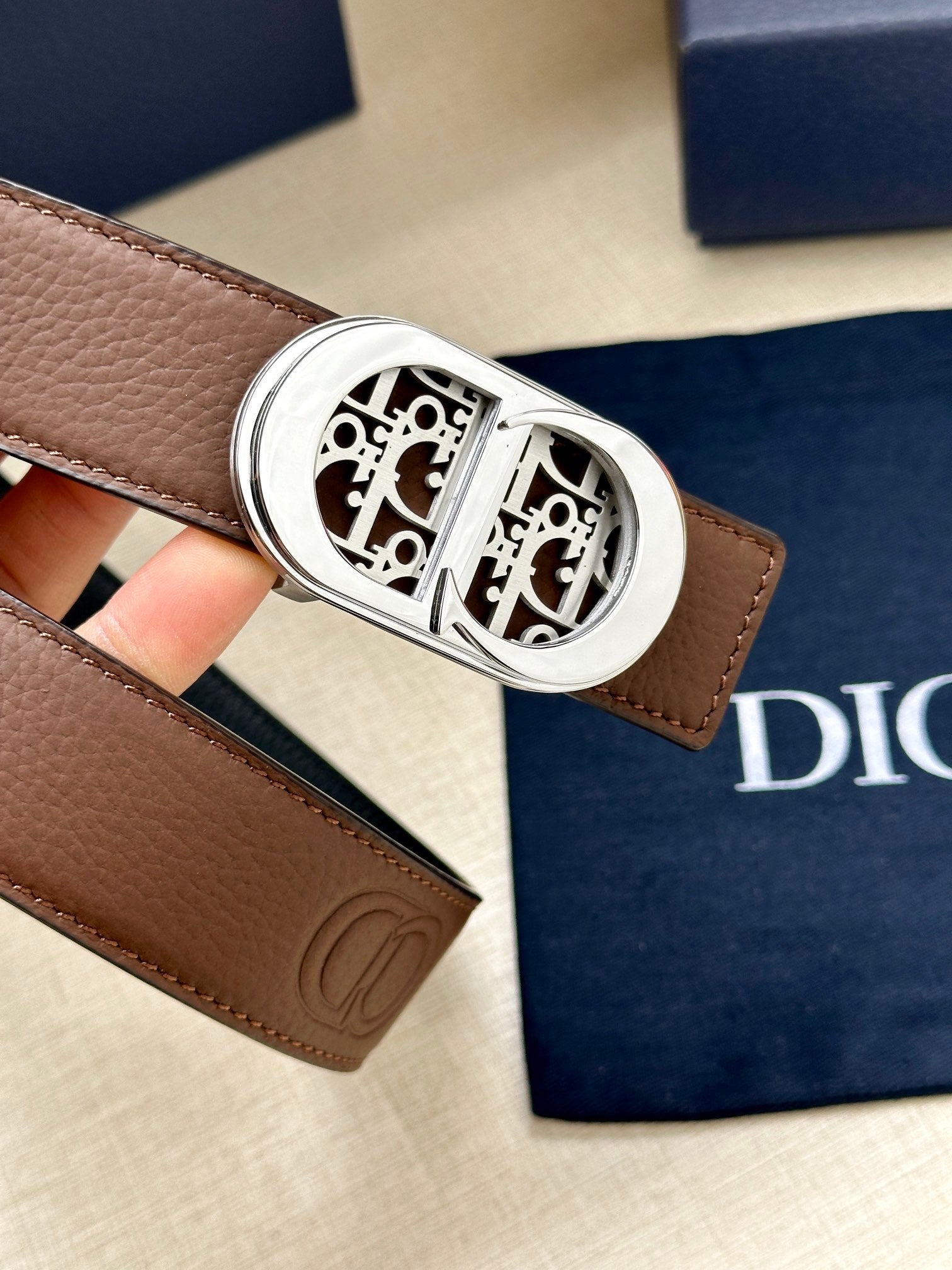 Dior leather belt close-up of brown strap and silver buckle