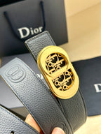 Dior leather belt detail: textured dark blue strap with gold-tone logo buckle