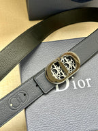 Dior leather belt close-up: textured dark blue strap and gold-tone logo buckle