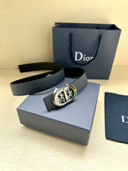Dior leather belt with dark blue strap and round gold-and-silver logo buckle