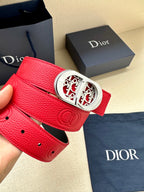 Red leather belt with silver-tone oval logo buckle and perforated hole line