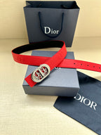 Red leather belt with silver-tone oval logo buckle, shown with gift box