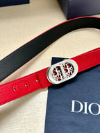 Red leather belt with silver-tone oval buckle and textured strap detail