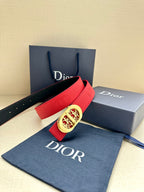 Red leather belt with gold-tone oval logo buckle and embossed strap panel