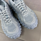 Light gray Balenciaga lace-up sneakers, front mesh and stitched overlays, chunky sole