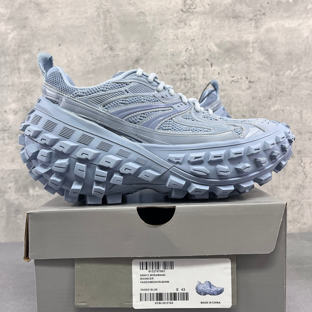 Light gray Balenciaga lace-up sneakers on box, chunky tread sole