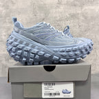 Light gray Balenciaga lace-up sneakers on box, chunky tread sole