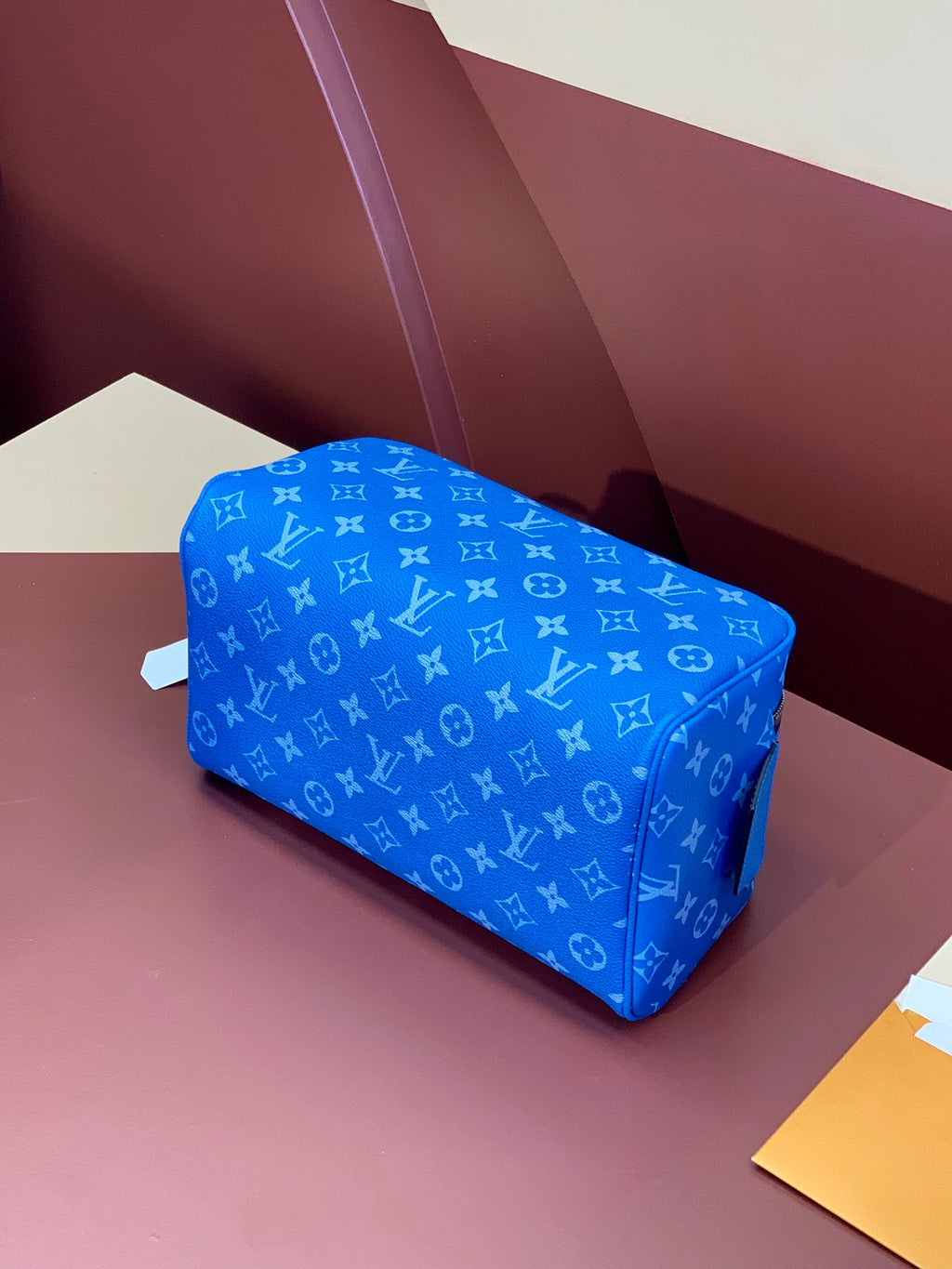 Louis Vuitton blue monogram mini bag angled view with top zip