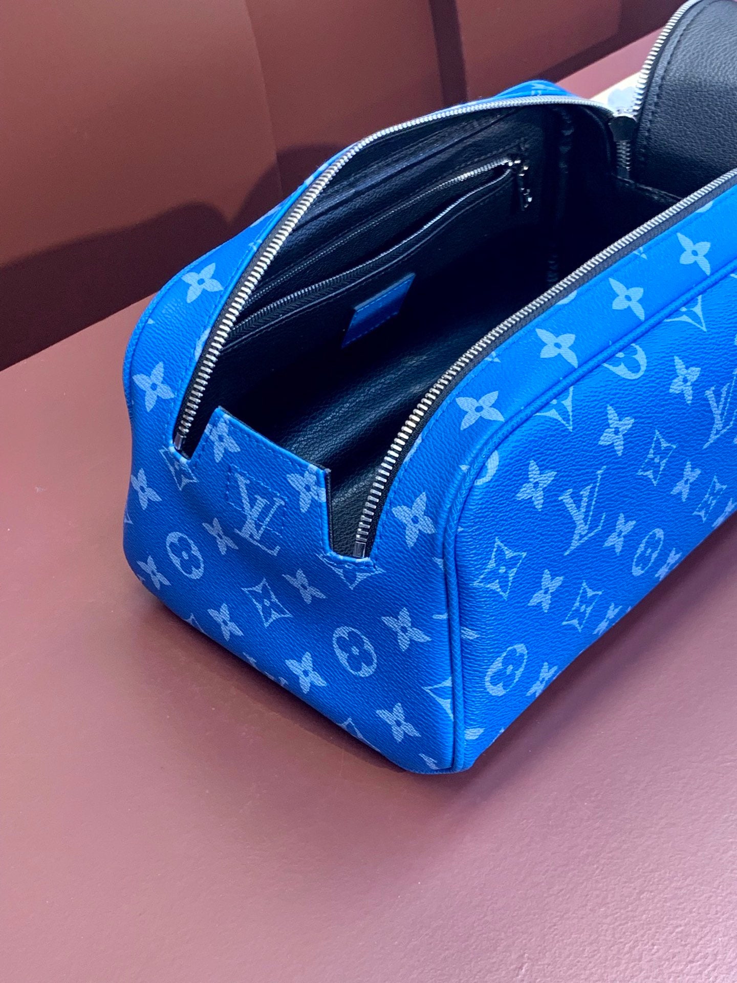 Louis Vuitton blue monogram mini bag with open interior and zip pocket