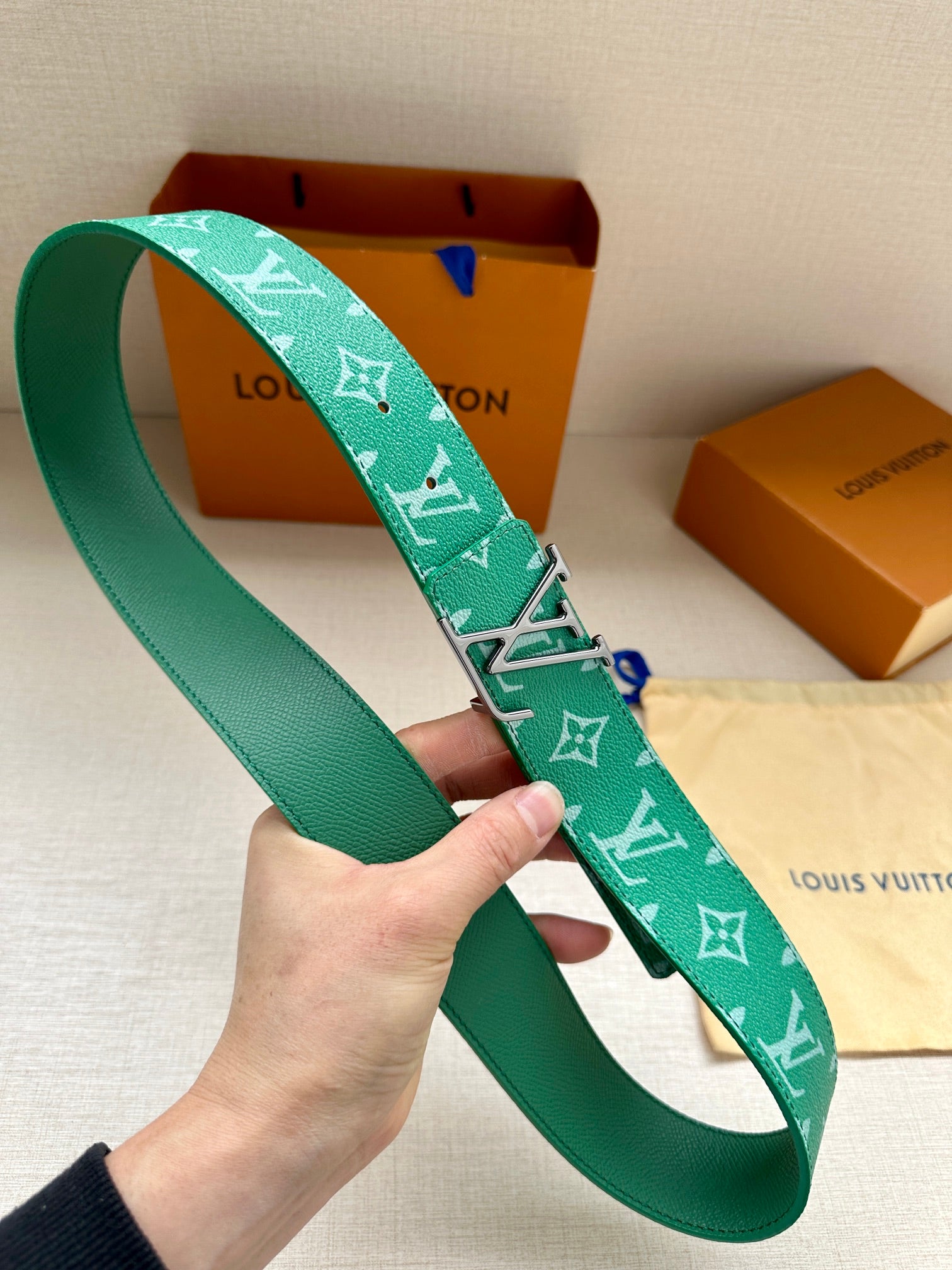 Louis Vuitton green monogram belt, side view with buckle and end holes