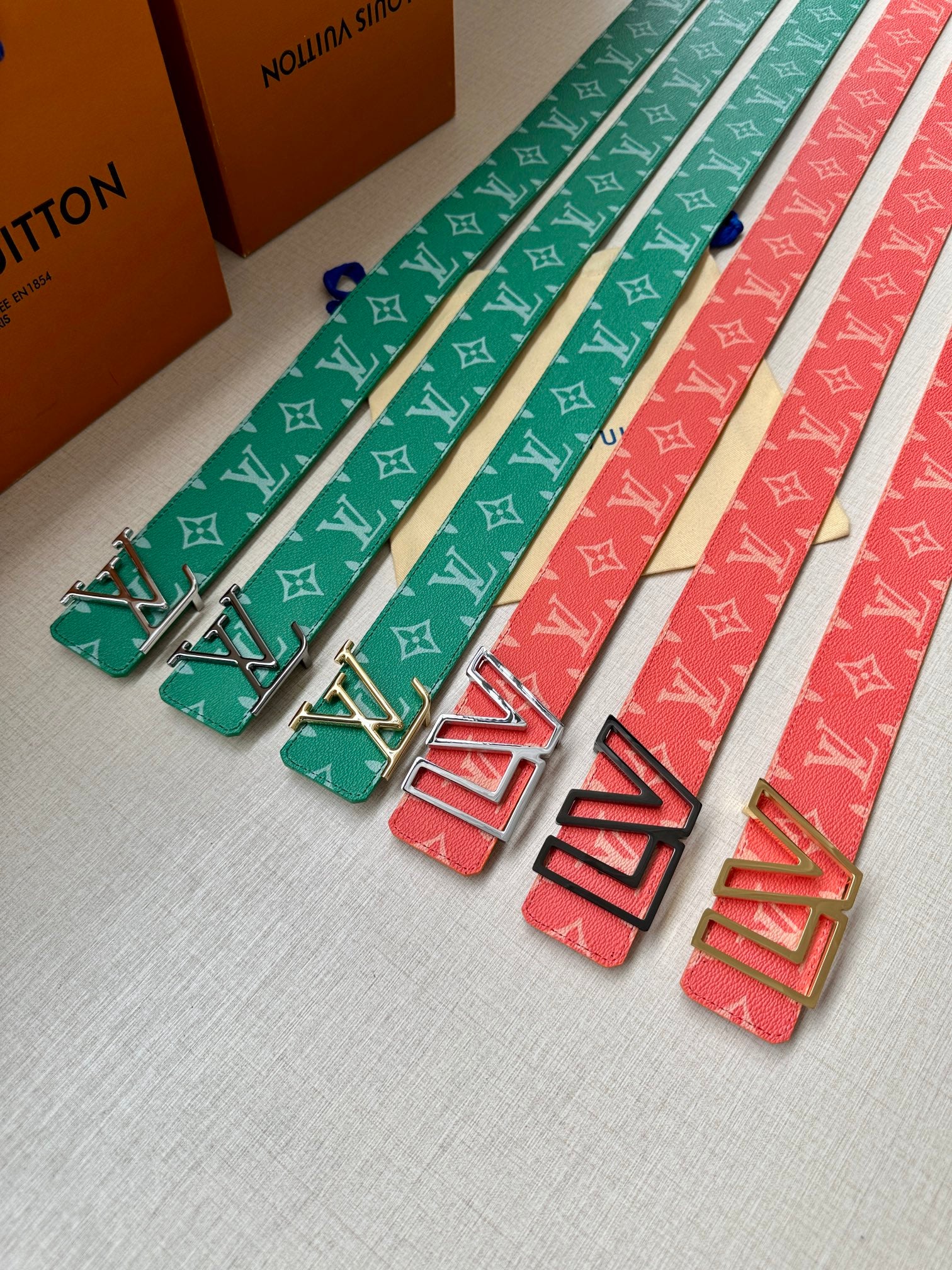 Set of Louis Vuitton monogram belts: green, blue, and red with matching buckles