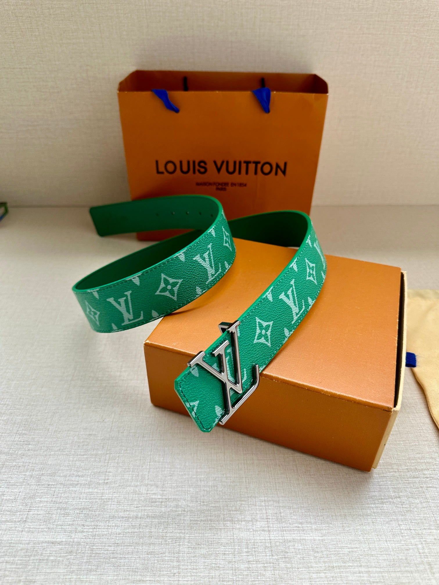 Louis Vuitton green monogram belt with LV buckle on folded canvas pouch