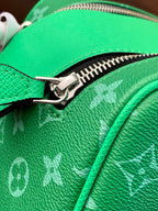 Louis Vuitton monogram bag zipper close-up on bright green pebbled leather