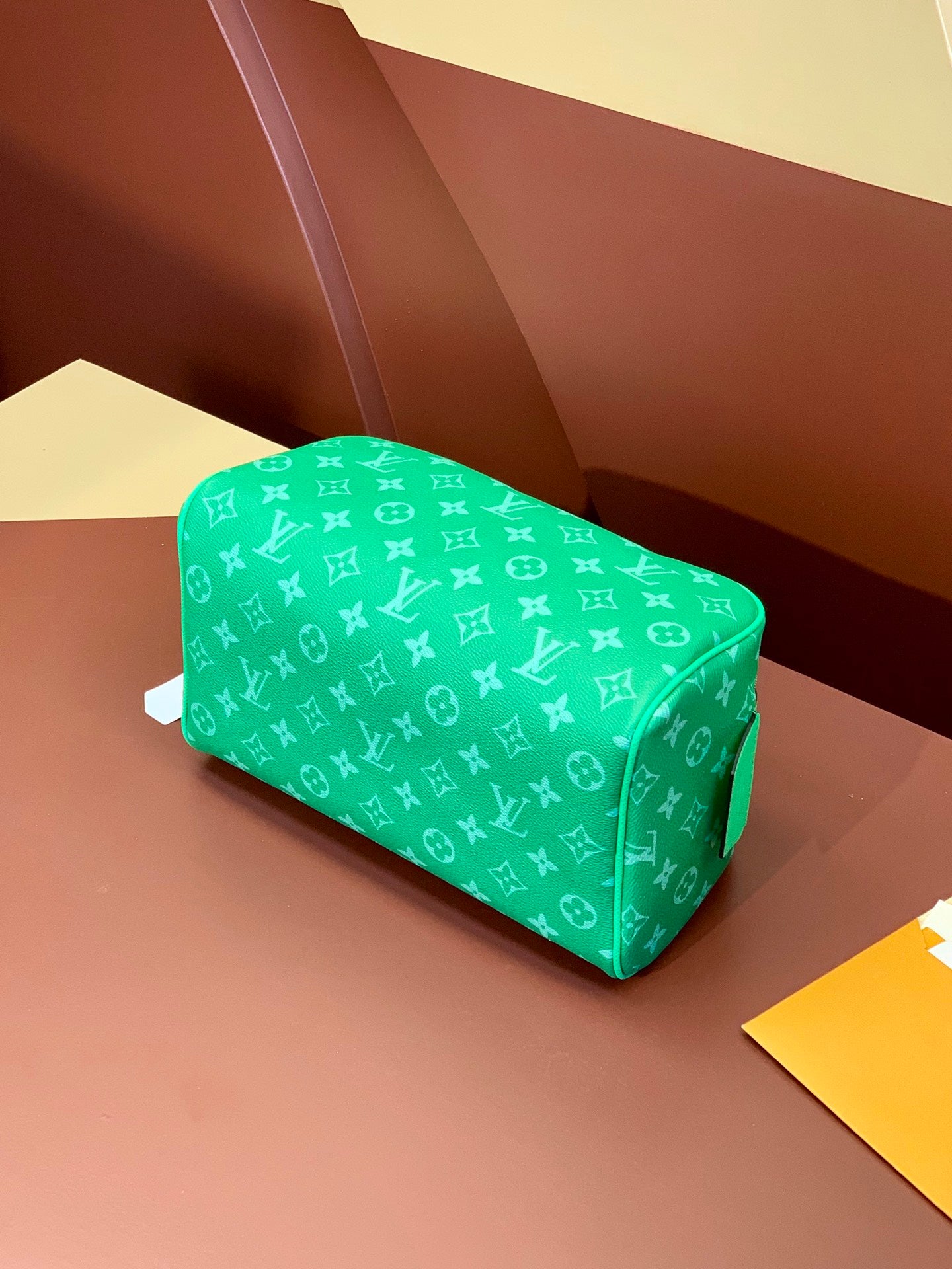 Louis Vuitton monogram bag in bright green with curved top and zip closure