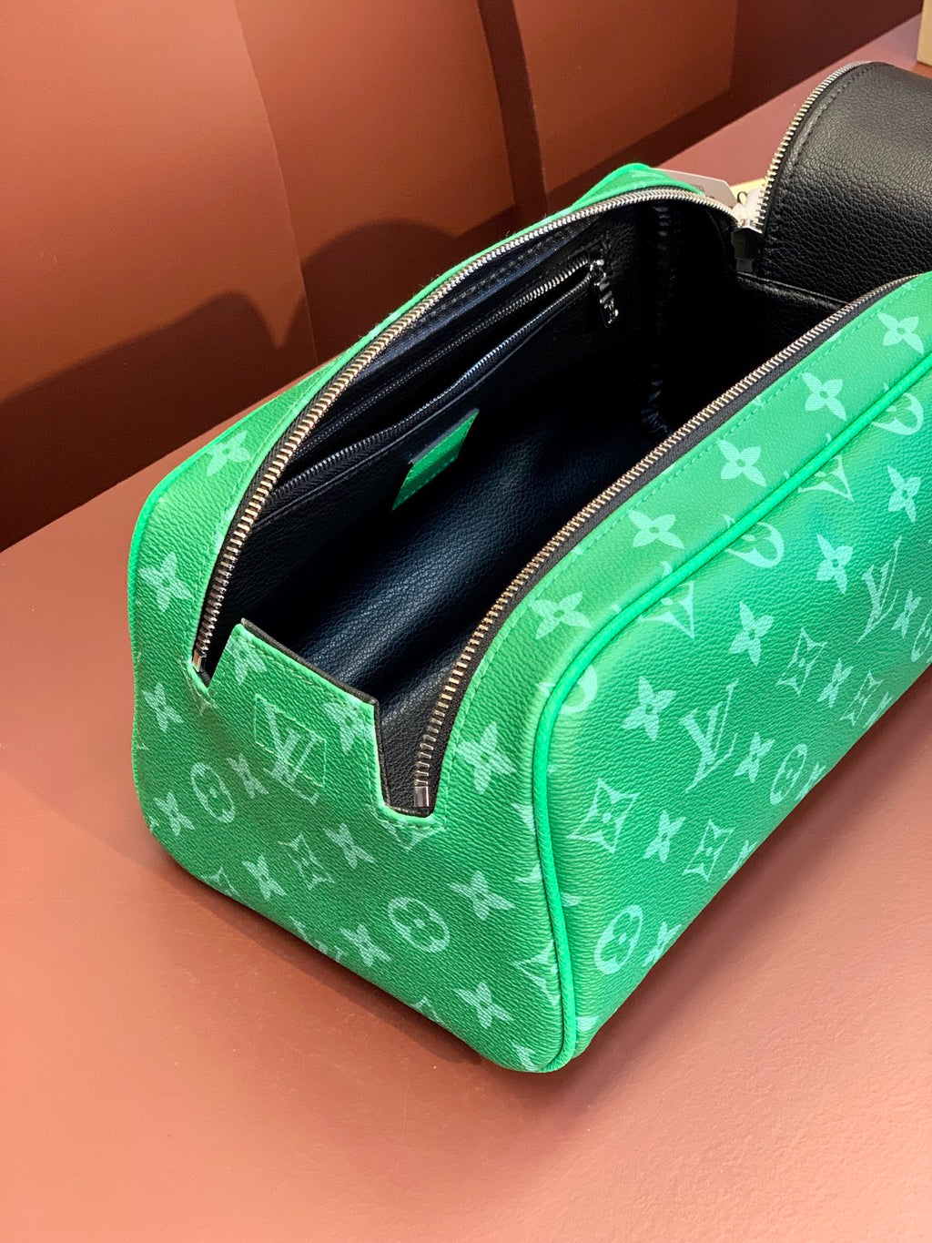 Louis Vuitton monogram bag with open top, black interior and green zip trim
