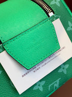 Green leather flap with printed care tag on Louis Vuitton monogram bag