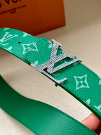 Green logo belt strap with textured leather and silver-toned buckle detail