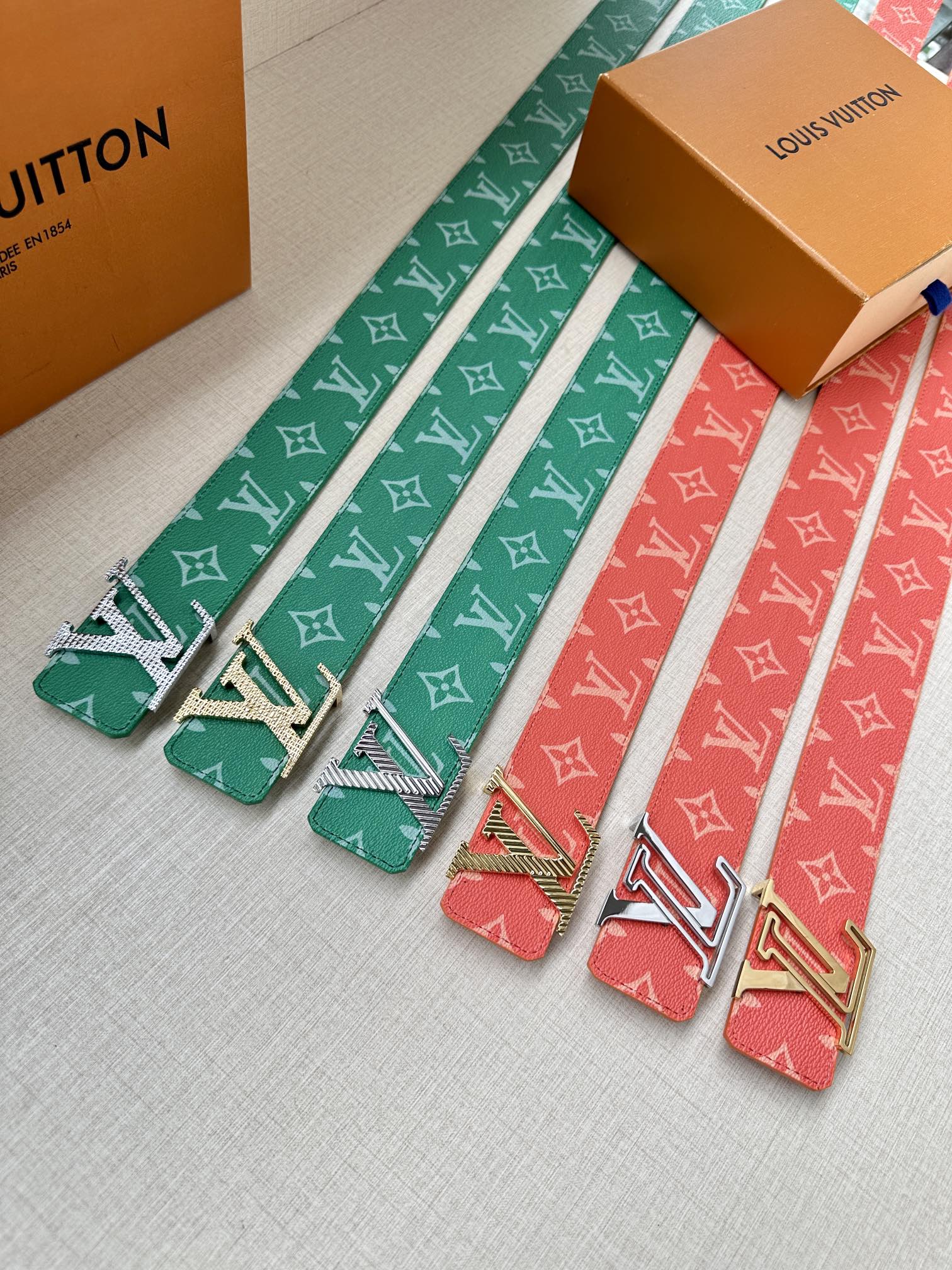Set of patterned belts with silver buckles: green and red straps