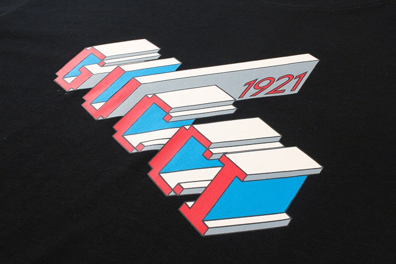 Gucci graphic T-shirt front detail with colorful stacked text and “1921”