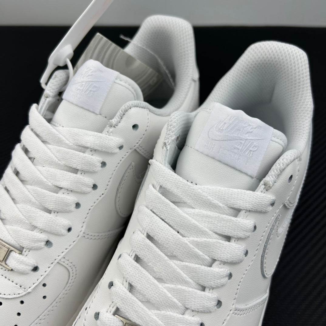 White Nike Air Force 1 sneakers, close-up of tongue, heel, and lace eyelets