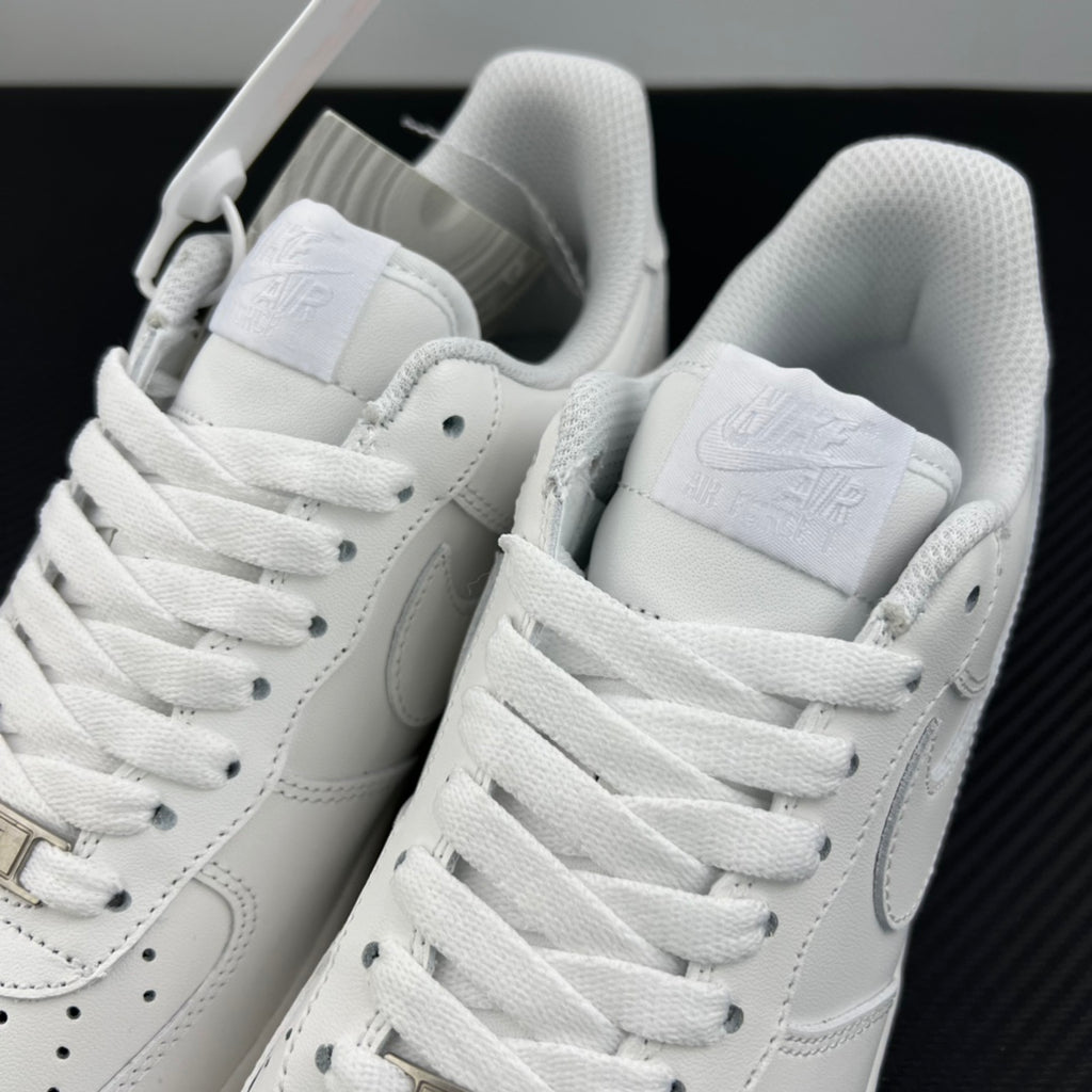 White Nike Air Force 1 sneakers pair, open collar with laces and heel pull tab