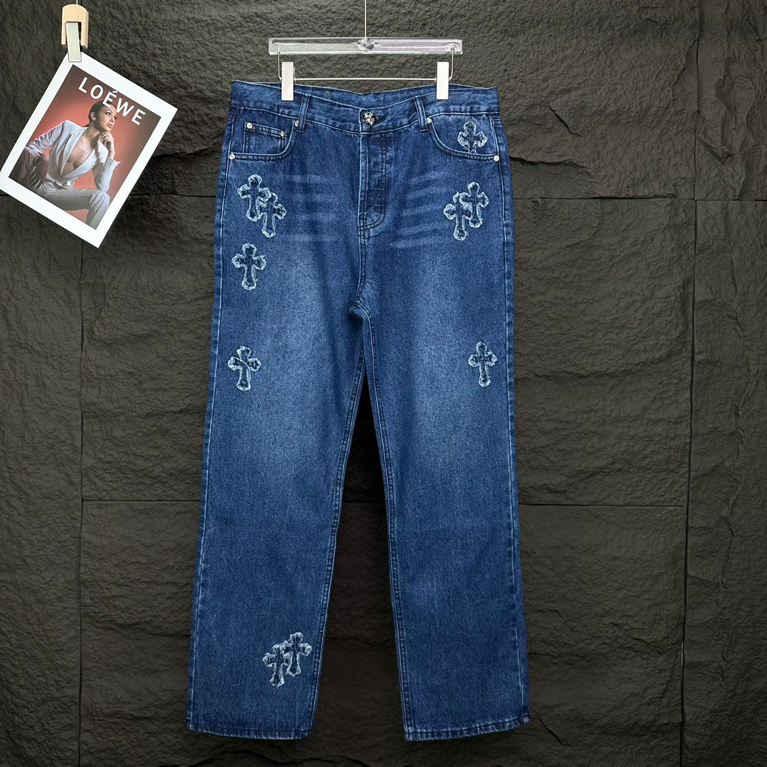 Blue denim pants with light cross embroidery on legs; button fly and belt loops.