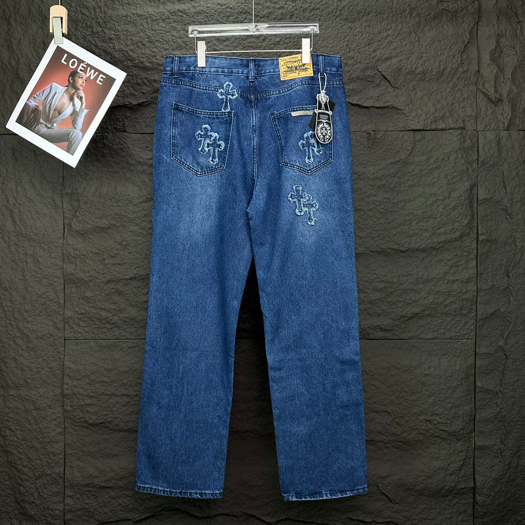 Blue denim pants with cross embroidery on back; rear pockets and small yellow label.
