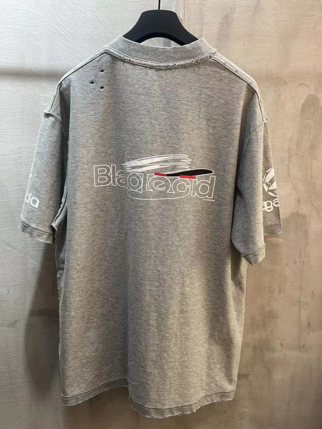 Light gray T-shirt with back graphic logo text and crew neckline