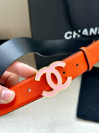 Chanel belt close-up: bright orange leather strap with white CC buckle