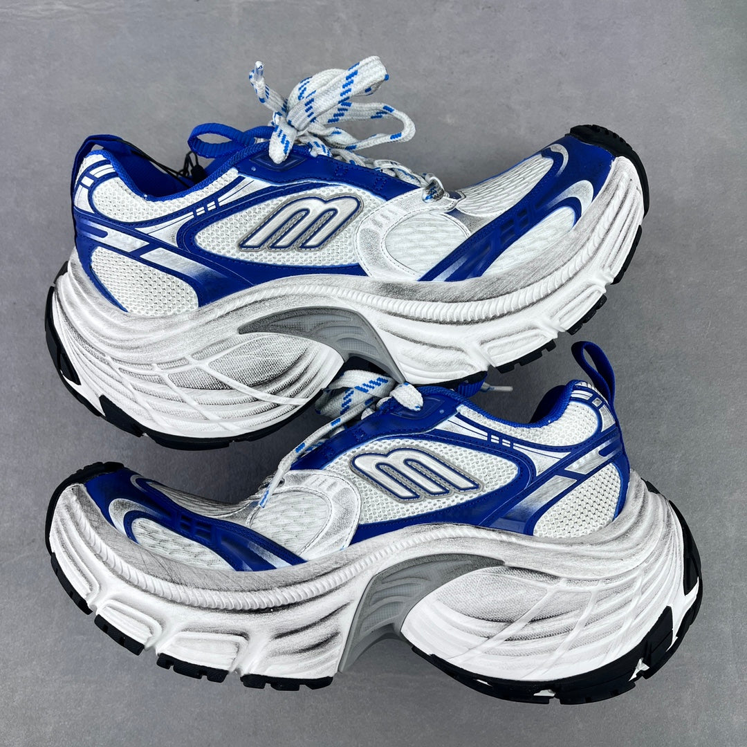 Two-tone white and blue chunky lace-up sneakers with thick sole and blue detailing