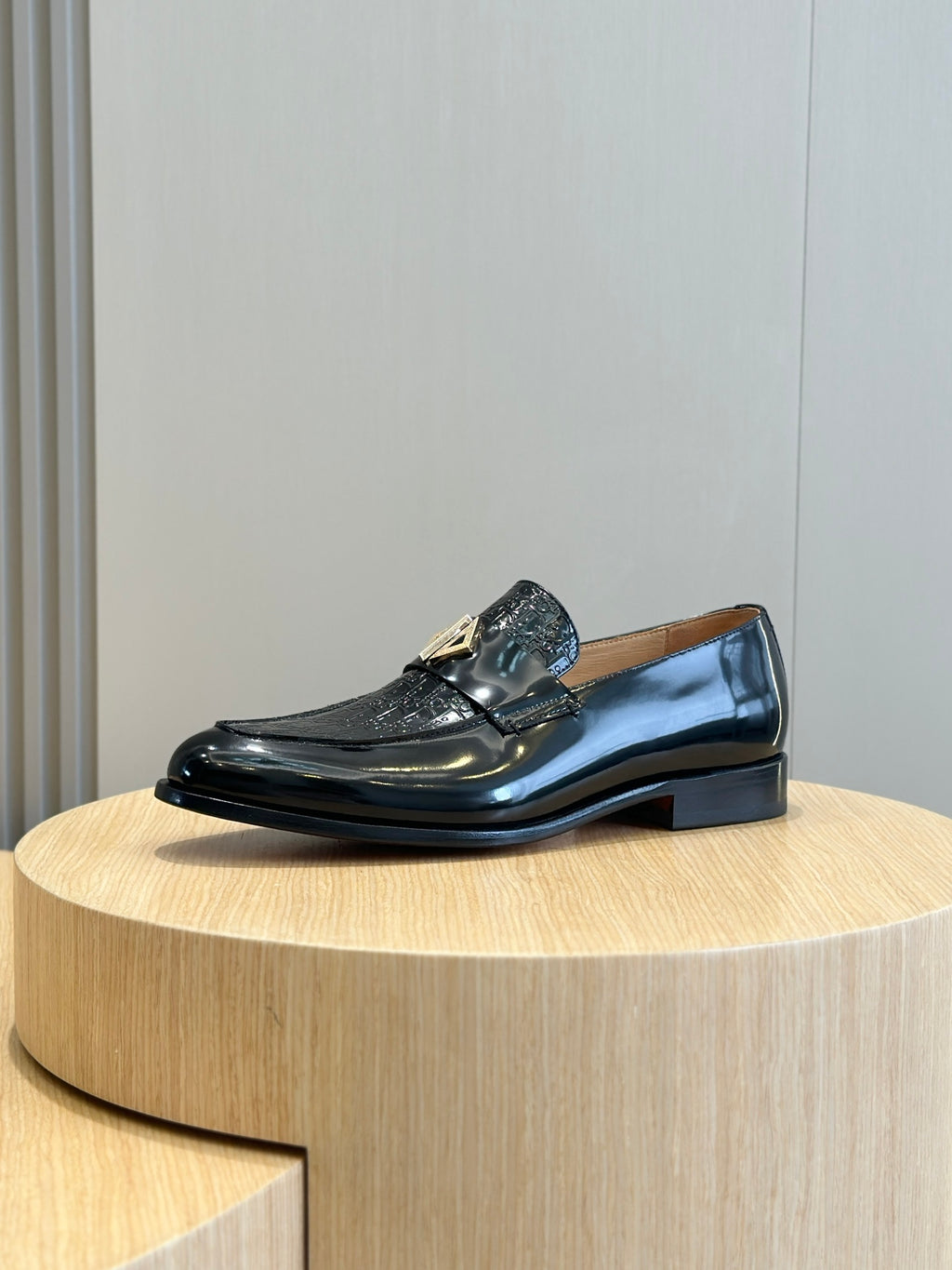 Dior unisex patent leather loafer with gold buckle accent, side view
