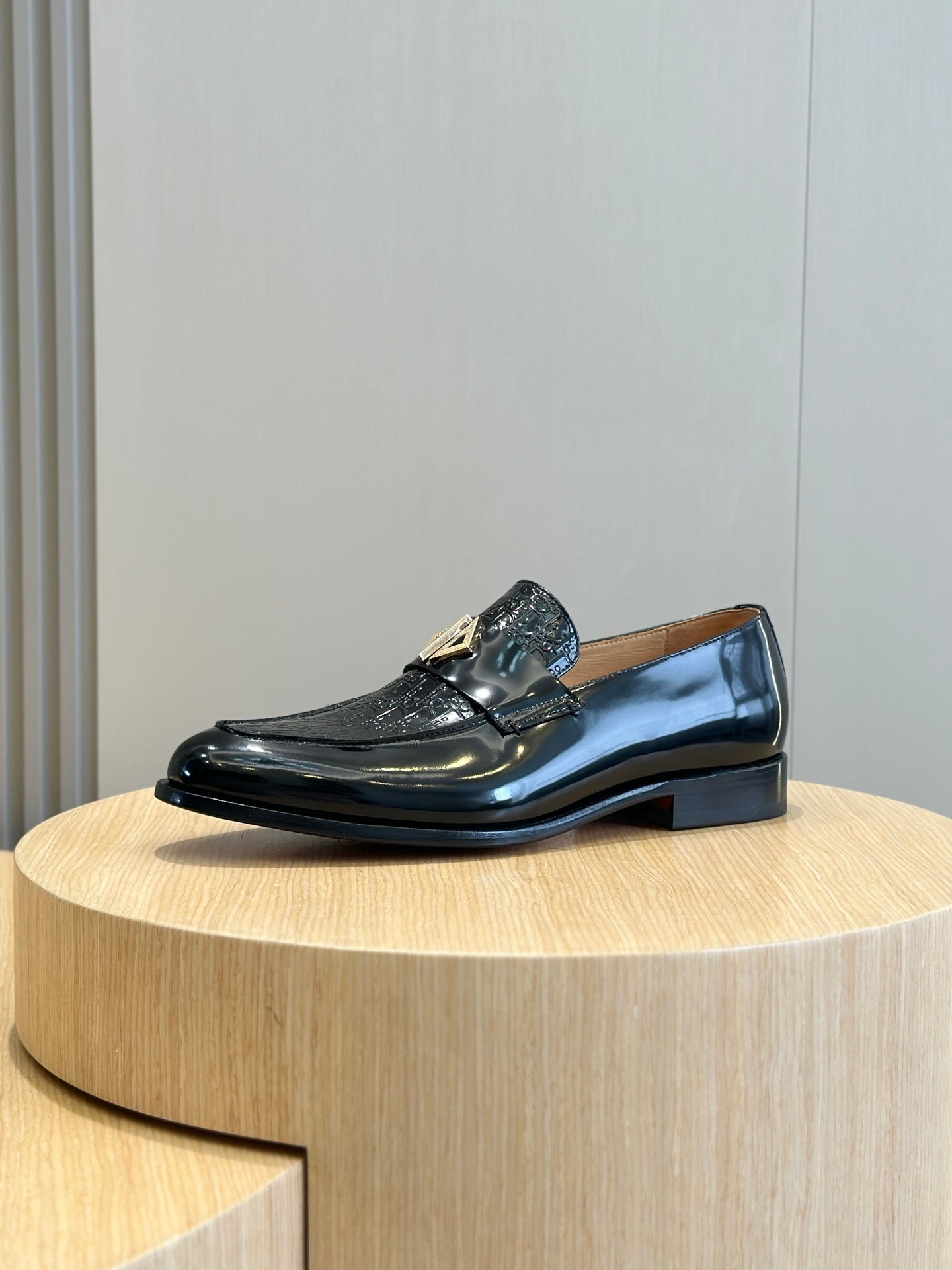 Dior unisex patent leather loafer with gold buckle accent, side view
