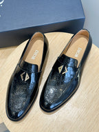Dior unisex patent leather loafers, black with gold emblem, front view