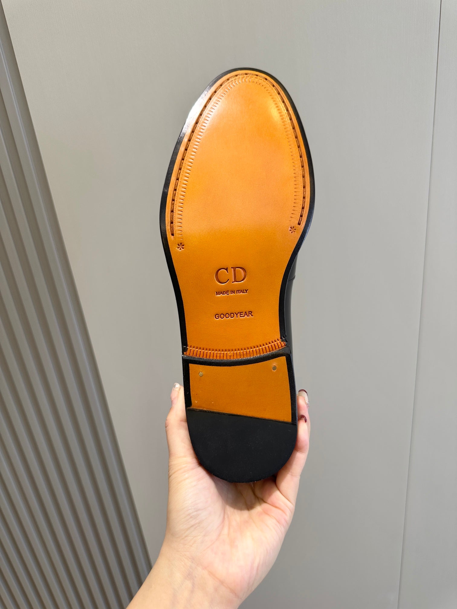 Dior unisex loafer outsole, amber leather with CD and Goodyear marks