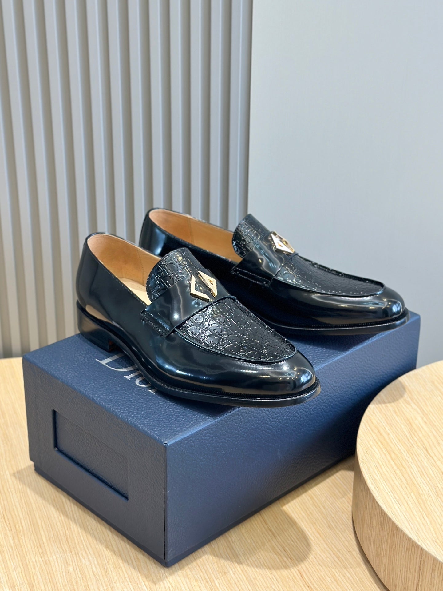 Dior unisex patent leather loafers, black with gold emblem, on box