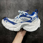 Unisex chunky sneaker side view in white and blue with lace-up and sculpted sole