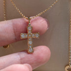 Bvlgari gold-tone cross pendant with clear pavé stones on a chain