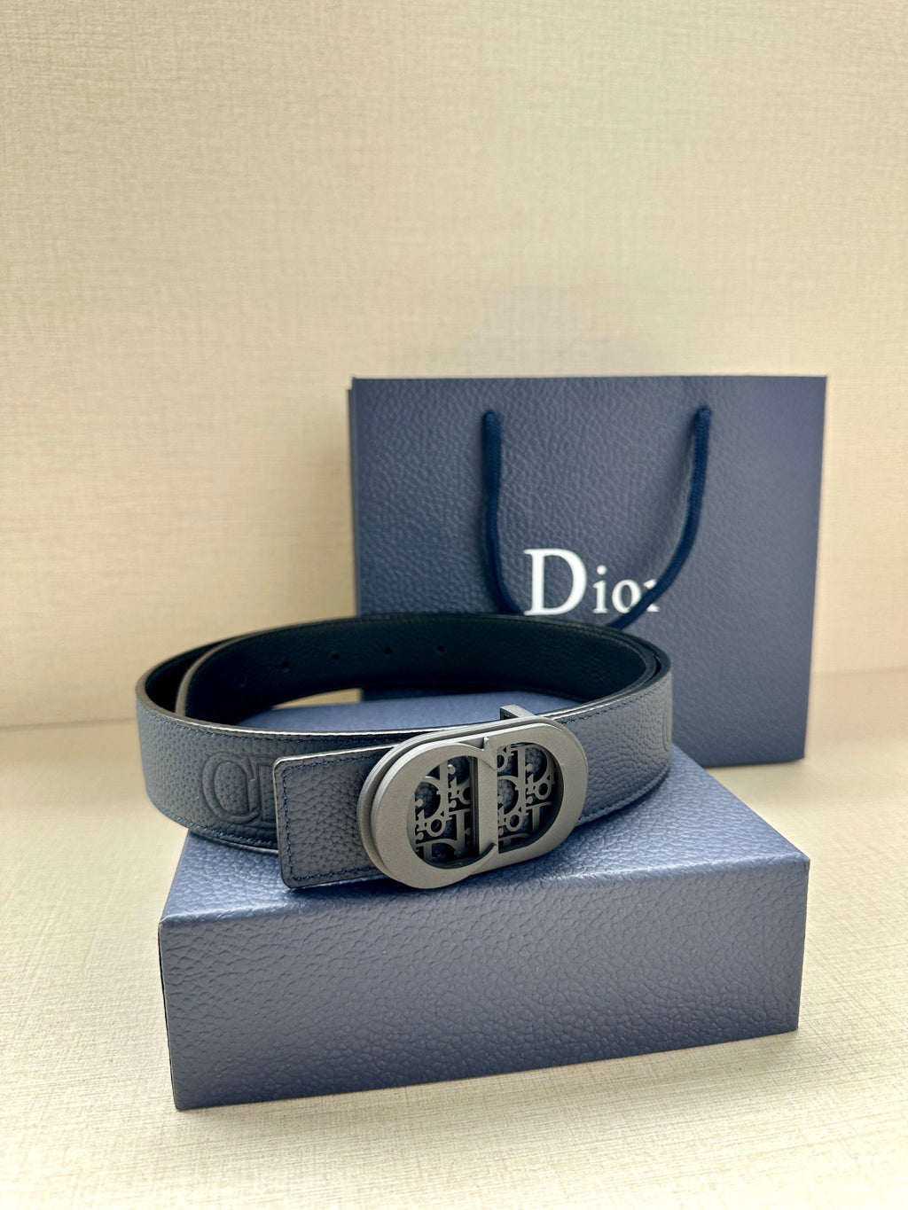 Dior leather belt with oval logo buckle and stitched texture